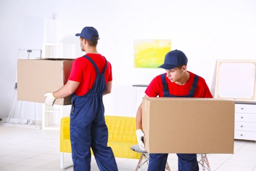 Furniture removals team handling a sofa in Shoreditch street