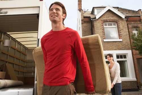 Careful loading of boxed belongings into a van for a local house move