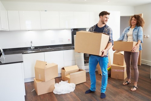 Professional movers loading household items into a van in East London