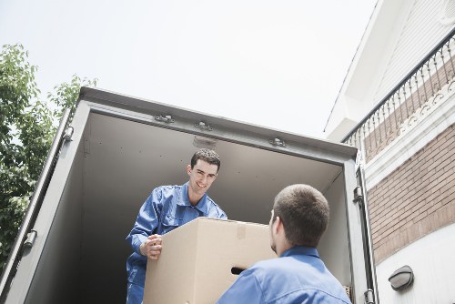 Professional movers loading boxes into a removal van in Shoreditch